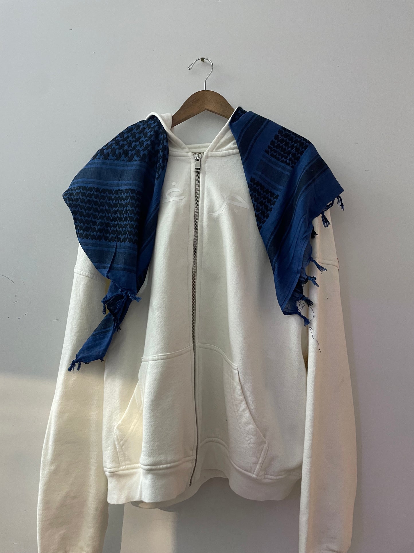 “Tajir Ghubar” White Hoodie with Blue Scarf